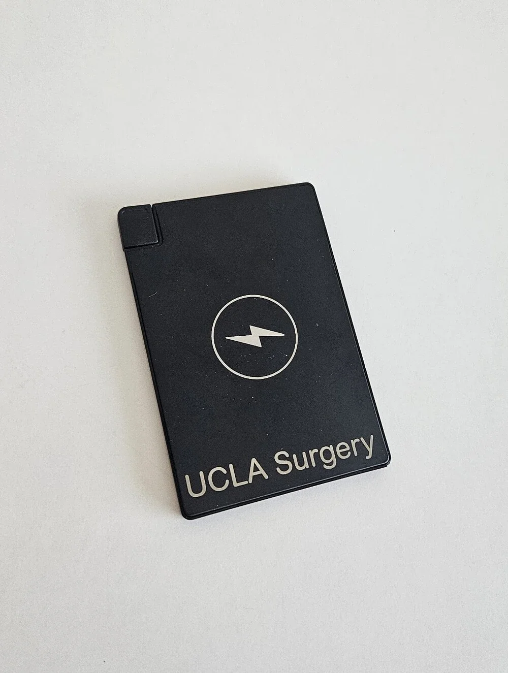 Clutch Thin Portable Charger Attached Charge Cable Lightning UCLA Surgery Phone